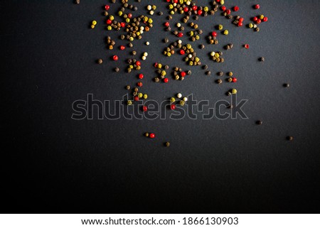 Close up of colourful pepper on black table background. Top view.  Free place