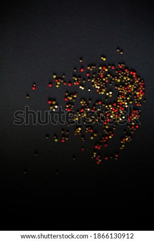 Close up of colourful pepper on black table background. Top view.  Free place