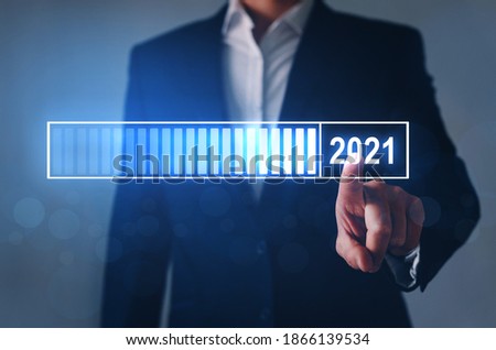 Loading new year 2020 to 2021 with businessman hand pointing digital loading bar.