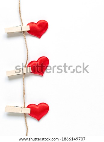 three hearts vertical hang on a thin rope with copy space