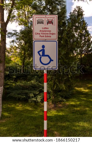 Regulation warning sign regarding the parking lot rule in public areas "please park your vehicles towards the exit direction"