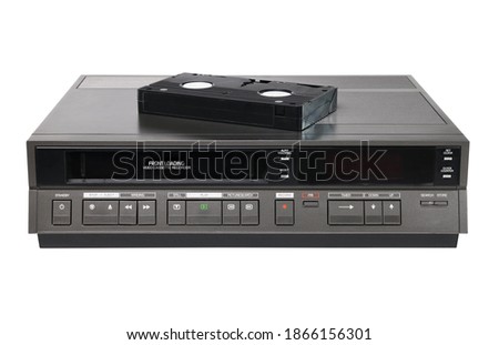 Old videocassette recorder 1980s-1990s with videotape isolated on white background. foreground Royalty-Free Stock Photo #1866156301