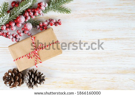 Christmas background with decorations and gift box on white wooden board