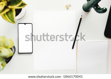 Smartphone on white table, work from home, office stuff