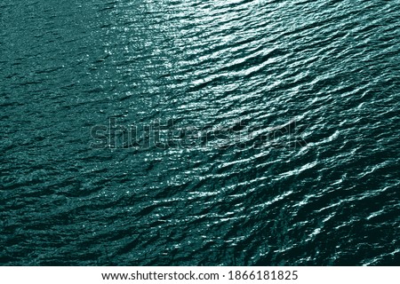 Tidewater green sea water texture. Tidewater green pool water with sun reflections. Trendy colour 2021 year. Dark tidewater green sea wave. Abstract monochrome texture. Color 2021 Royalty-Free Stock Photo #1866181825