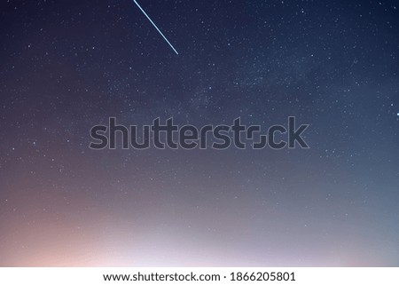Milky Way and satellite in the night sky.