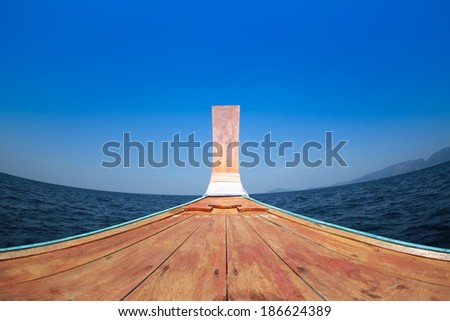 wide angle shot of fishing boat with blue sky in thailand