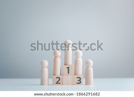 Business hierarchy, ranking and strategy concept with wood doll standing on a podium 1, 2, 3 of wooden building blocks with copy space. Royalty-Free Stock Photo #1866291682