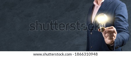 Innovation, idea, creative concept of hand hold a light bulb and copy space for insert text. Businessman giving a bulb lamp idea. Business and Innovative idea concept design. banner