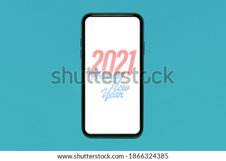 Text of Happy new year 2021 on white screen of smartphone, isolated on pastel blue background. Resolution concept; new start.