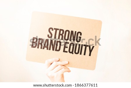 Closeup Business man hand holding show blank paper sheet mock up empty white board space for shouting text rule or protest word. Text STRONG BRAND EQUITY