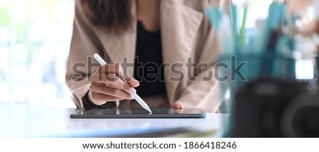 Cropped shot of a creative designer female is drawing on digital tablet.