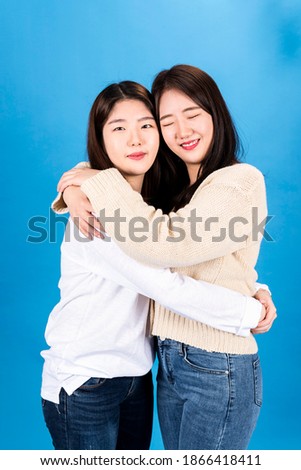 Two women hugging each other