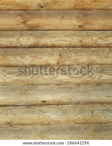 close-up part of the wall of a new wooden hut in daylight