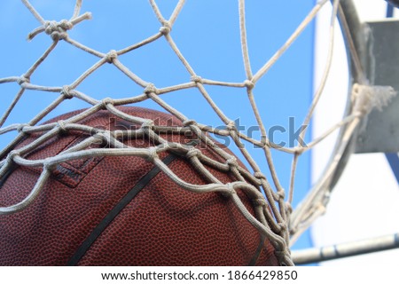 Basketball in rim, perfect shot