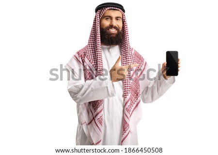 Arab man holding a smartphone and pointing isolated on white background