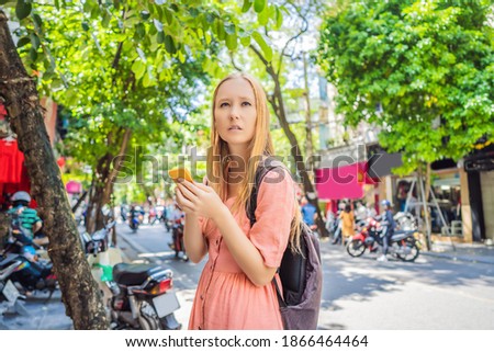 Woman using phone app for taxi ride hailing service or reading travel guide. Girl tourist searching for map directions on smartphone. Copy space