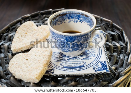 Cup of coffee on a support with hearts from toasts