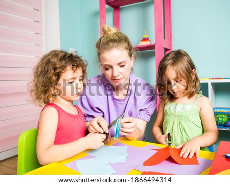 The kids perform a creative task with the teacher