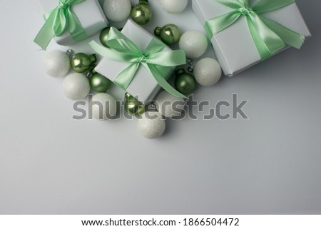 White gifts with mint ribbons. Set of gift box isolated on white background.Christmas gift boxes on white background. Beautiful Christmas background with shiny balls and ribbons in pastel mint color.