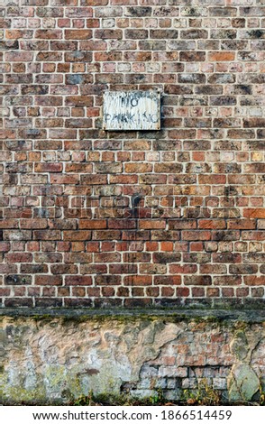 No parking sign on an old wall. 