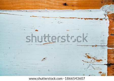 Wooden background half painted with blue paint