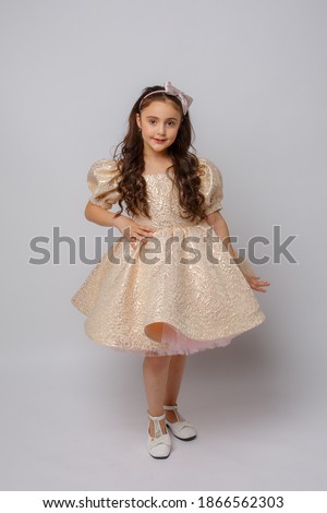 little girl in a beautiful dress on a white background