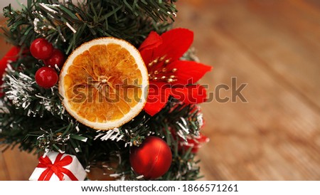 Christmas decoration against wooden blurred background with Christmas tree, dried fruits