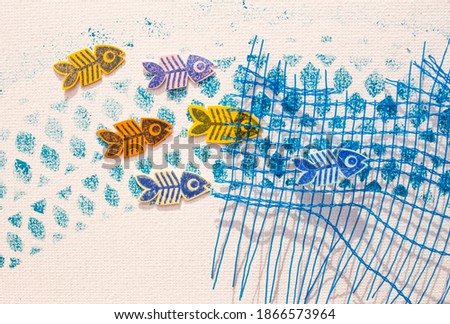 Conceptual photography. Dead fish skeletons, caught by the fishermen's net, in the polluted sea. Printed canvas with drawings made by stamps. Summer crafts.