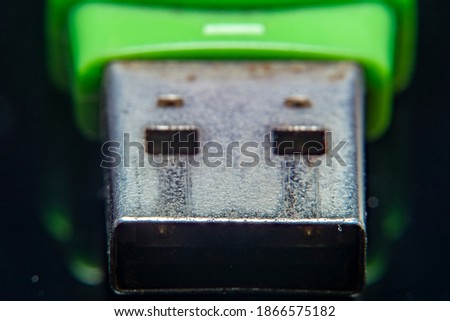 Blurred at high magnification image of contacts of a used USB format memory stick with characteristic traces of damage on the metal.
