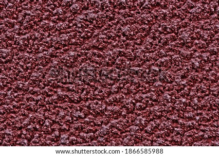 Abstract background in the color of Bordeaux. An empty rough surface for an ad or advertisement. 