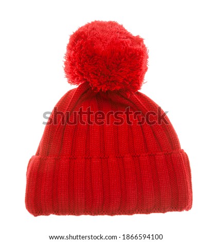 Red knitted winter bobble hat of traditional design isolated on white background. Handmade woolly cap with pompom on top Royalty-Free Stock Photo #1866594100