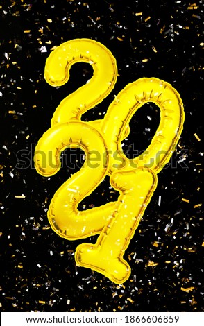 2021 Happy New Year numbers text. Golden metallic foil balloons and confetti on black background flat lay. Christmas party holiday greeting decor. Banner, postcard template. Wallpaper clipart