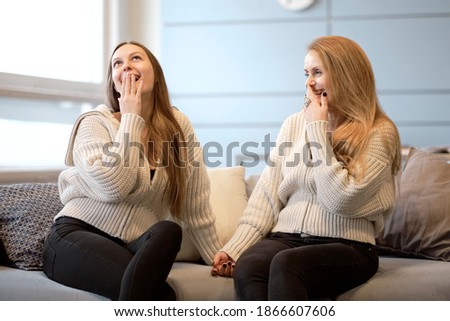 Happy senior mother embracing adult daughter laughing together, smiling excited aged older lady hugging young woman, sincere family of different age generations bonding talking joking having fun
