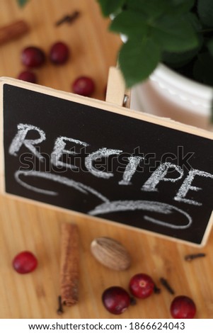 Vintage.  Recipe on blackboard. Dashboard isolated on a wood background. Great top view. Food, kitchen. Spices. White chalk