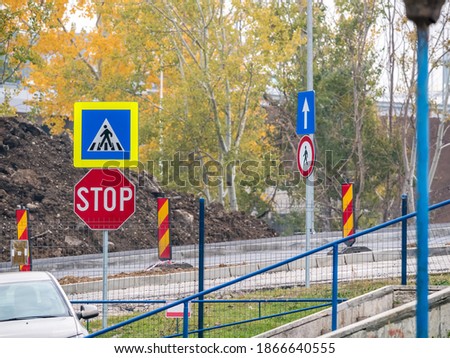 Pedestrian crossing traffic sign and stop traffic sign in a construction area in Bucharest