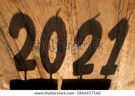 The shadow of the number 2021 on the wooden floor Happy New Year ideas