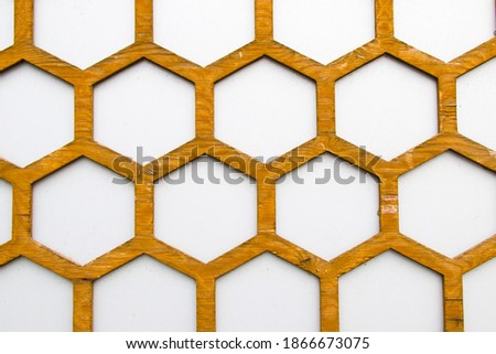Honeycomb background, wooden comb and white wall texture