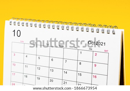 Close up October 2021 Calendar desk for organizer to plan and reminder on yellow background. Royalty-Free Stock Photo #1866673954