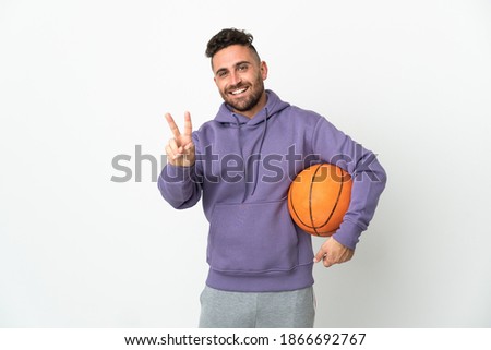Basketball player man isolated on white background smiling and showing victory sign