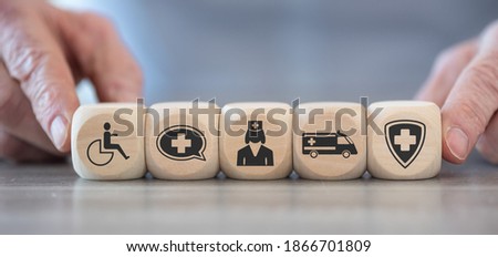 Concept of disability with icons on wooden cubes