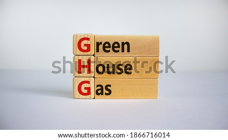 Greenhouse gas symbol. Concept words 'GHG, greenhouse gas' on cubes and blocks on a beautiful white background. Business and GHG concept. Copy space.