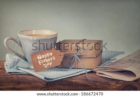 Gift box with a tag and a cup of coffee Royalty-Free Stock Photo #186672470