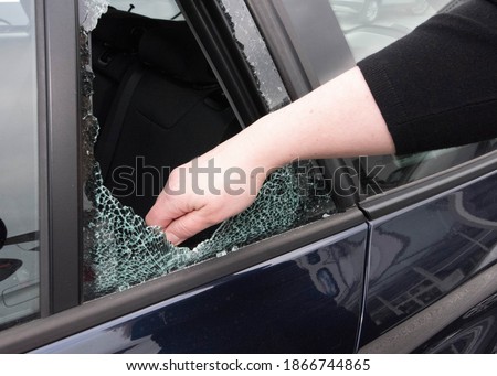 breaking into a car, car theft and stealing as a criminal offense Royalty-Free Stock Photo #1866744865