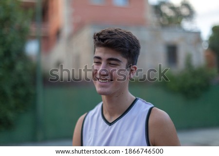 Portrait of a teenage boy playing basketball.