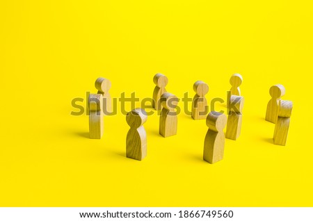 Figures of people stand randomly on a yellow background. People society concept. Behavior and social science relationships. Human resources. Personnel Management. Large group crowd Royalty-Free Stock Photo #1866749560