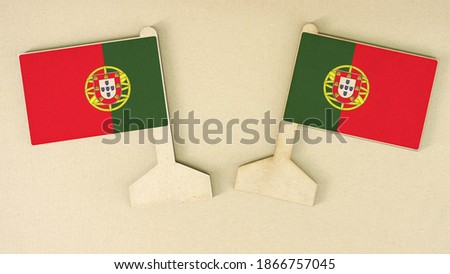 Flags of Portugal made of recycled paper on the cardboard desk, flat layout