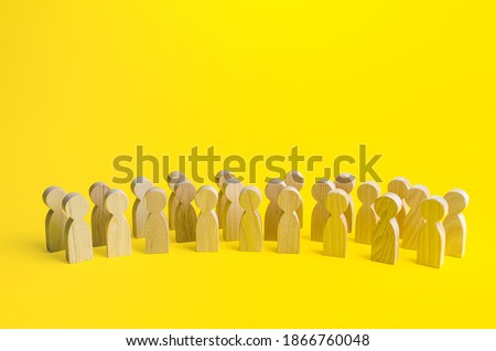 A large group of figurines of people on a yellow background. Social survey and public opinion, electorate. Population and citizens. Human resource, search for candidates. Personnel Management. Royalty-Free Stock Photo #1866760048