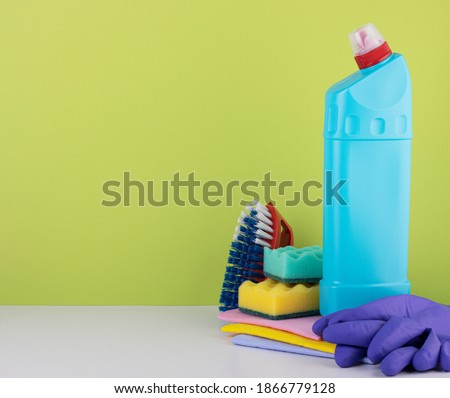 cleaning products on a green background with space for text. the concept of cleaning and cleanliness