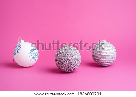 Christmas New Year composition. Gifts, silver and white ball decorations on pink background. Winter holidays concept. Angle view